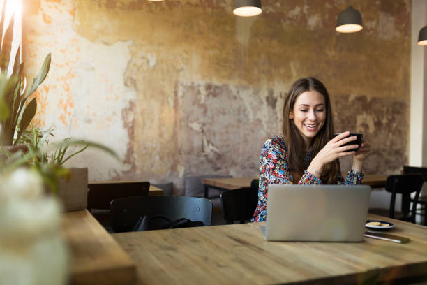 istock Young woman with laptop in cafe 1134291274