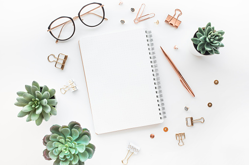 Elegant work table with business accessories on withe background.luxury feminism style