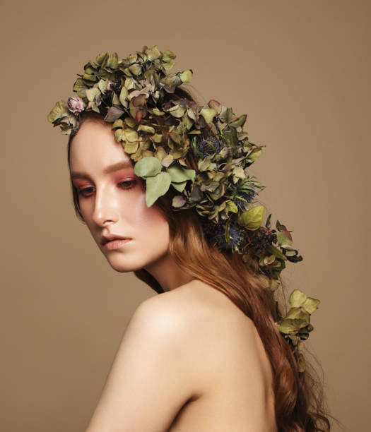 istock Beautiful young woman and flowers 1134292697