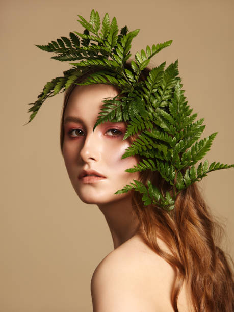 istock Beautiful young woman and leaves 1134292724