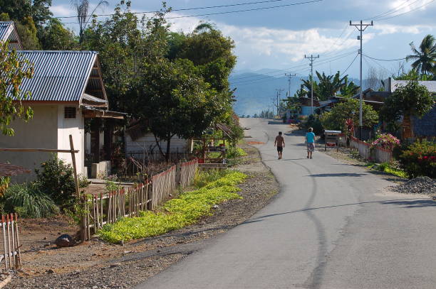 Tentena, Sulawesi - August, 13, 2012: people walking in the main street of Balinese village. Tentena is a charming small town in Central Sulawesi. The town is next to the serene Lake Poso
