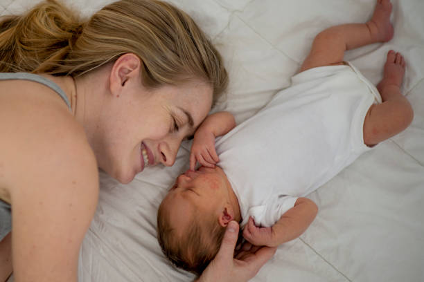 istock Mother and newborn on a bed 1134293501