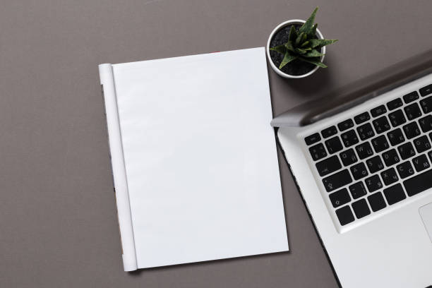 istock office desk top view with blank notebook  isolated on gray, with clipping path, changeable background. Blank page or notepad on wood background. Blank page or notepad for mockups or simulations. 1134294303