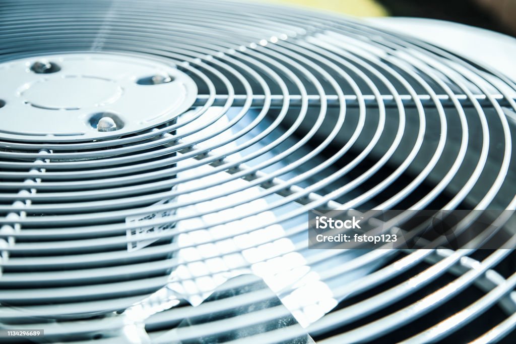 Home air conditioner unit in summer season. Top view of an air conditioner unit outdoors in hot summer season.   No people. Air Conditioner Stock Photo