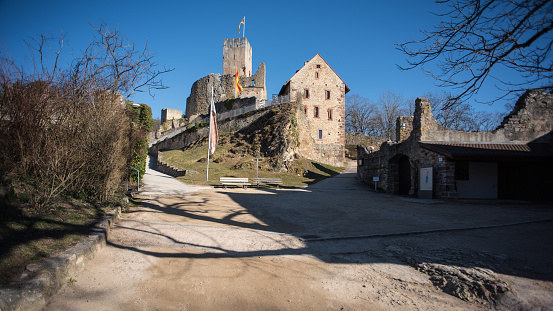 Ruins of a medieval castle with a Hungarian flag near Döbrönte on a sunny day in springtime.