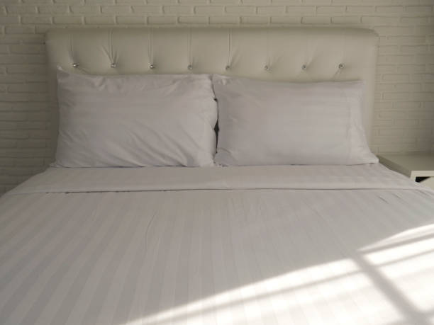 istock Double bedroom with white pillows and blanket. 1134298924