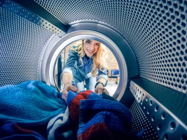 Photo of Young woman having a laundry day
