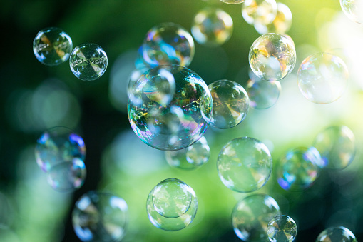 Colorful soap bubbles outdoors, summer time, fun