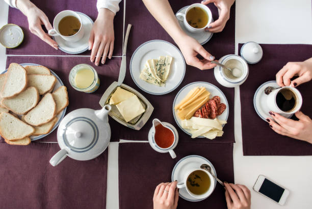 istock People eat healthy meals with tea and coffee at white served table. 1134302396