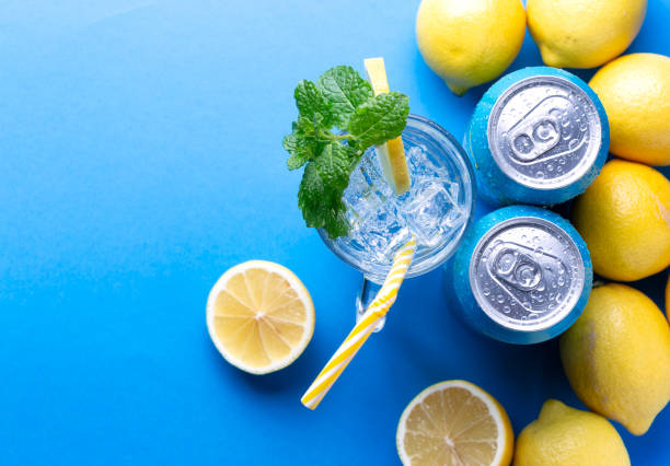 Soda drink with lemon and aluminium cans stock photo