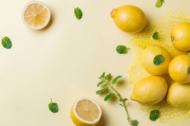 istock Lemons and mint leaves on yellow table 1134304333