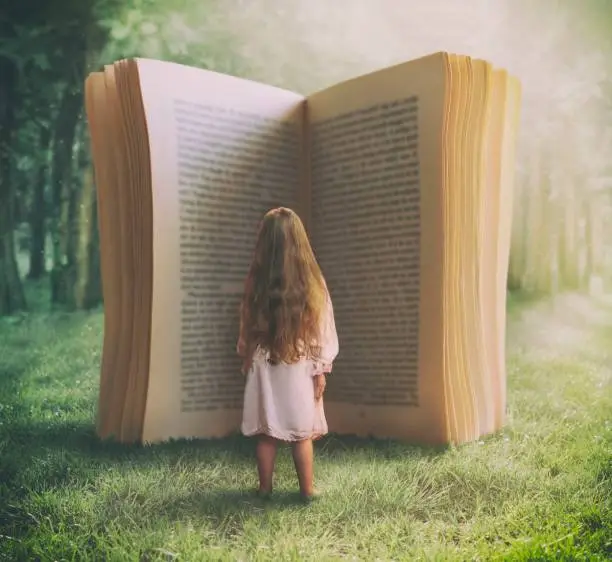 Surreal photo compilation of little girl standing in front of the huge open book in nature.