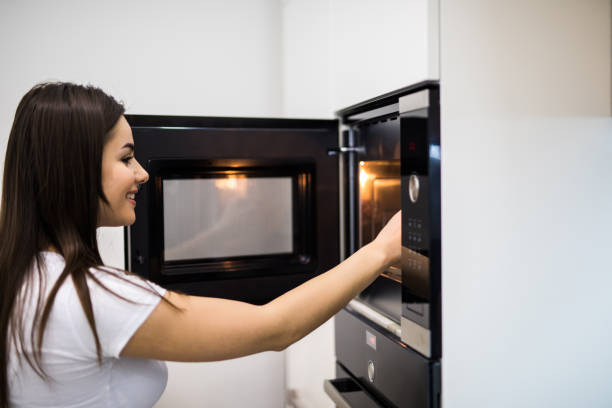 istock A young woman is opening the oven in her modern kitchen 1134306050