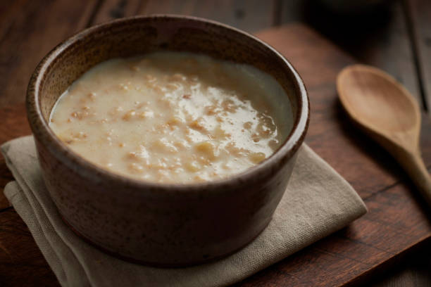istock rustic bowl filled with Porridge on an aged wood table top. 1134307016