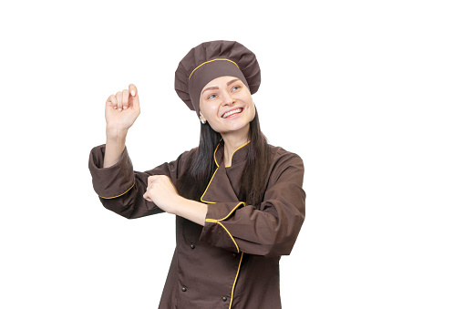 Portrait of a cheerful dancing chef in brown uniform isolated on white background
