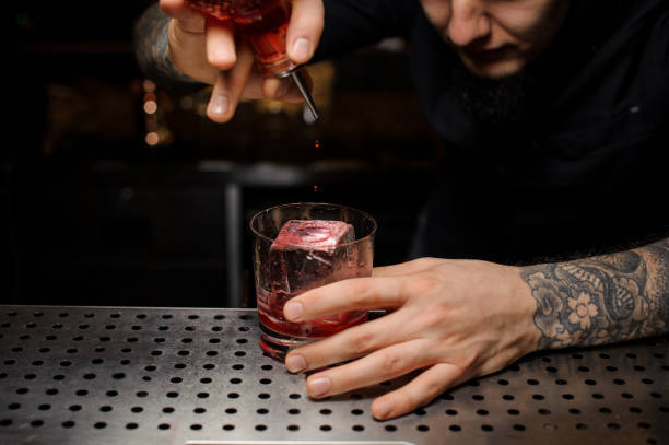 istock Bartender adding to the cocktail glass with ice cube a bitter from the dasher bottle 1134310818