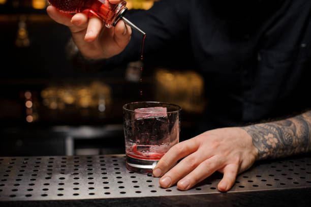 istock Professional bartender adding to the delicious cocktail a bitter from the dasher bottle 1134311078