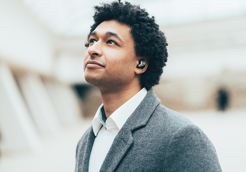 Portrait of Young elegant afro-american man with Wireless earbuds