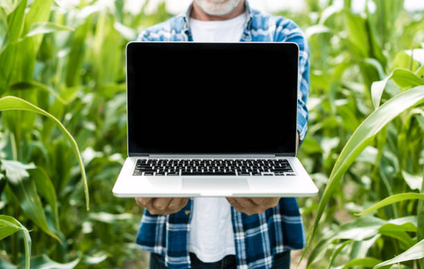istock Farmer in the field showing laptop screen, closeup 1134312074