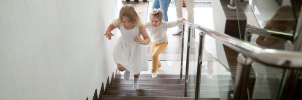 istock Children going upstairs to second floor their new modern house 1134312125