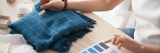 istock Horizontal closeup image female designer hands and blue shades samples 1134312158