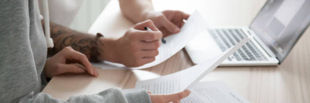 istock Horizontal photo female male checking bills documents sitting at desk 1134312160