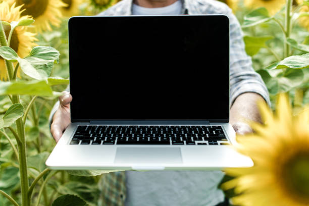 istock Farmer in the field showing laptop screen, closeup 1134312255