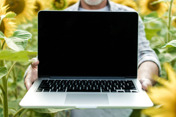 istock Farmer in the field showing laptop screen, closeup 1134312266