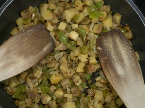 istock eggplant, onion and green pepper fried in a pan 1134315019