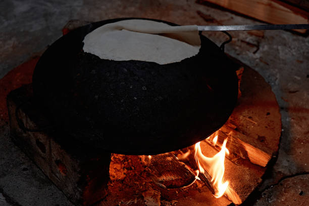 istock Pita bread baking on a saj or tava on fire, close-up 1134315305