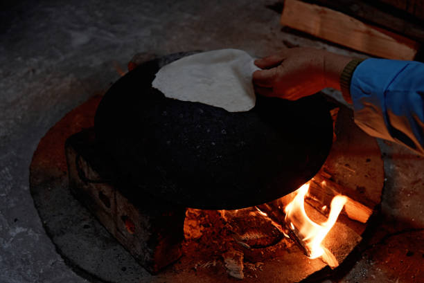 istock Pita bread baking on a saj or tava on fire, close-up 1134315308