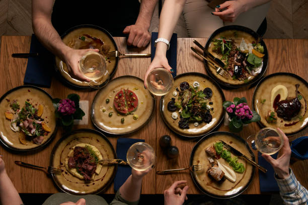 istock Group of people having dinner together while sitting at the table 1134315714