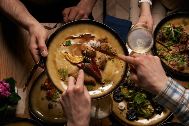 istock Top view of people having dinner together while sitting at wooden table 1134315743