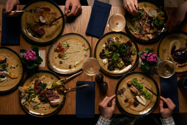 istock Top view of people having dinner together while sitting at wooden table 1134315744