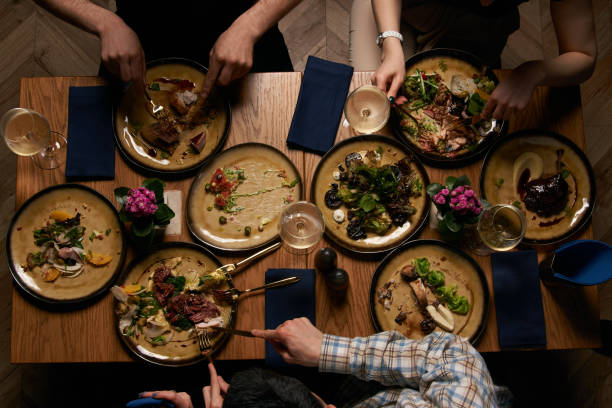 istock Top view of people having dinner together while sitting at wooden table 1134315747