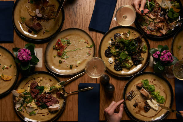 istock Top view of people having dinner together while sitting at wooden table 1134315753