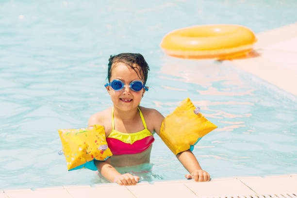 istock A girl playing in a summer swimming pool 1134317427