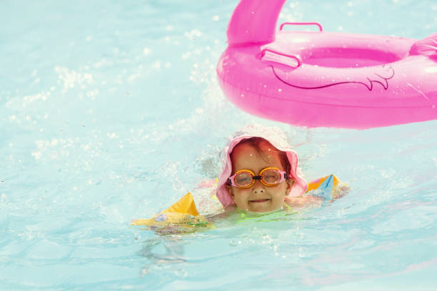 istock A girl playing in a summer swimming pool 1134317479