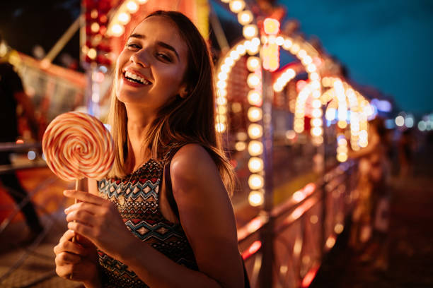 Portrait of a beautiful young woman having fun at the amusement park