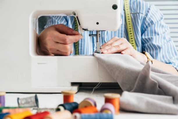 istock Seamstress working with electrical sewing machine in tailor shop 1134322750