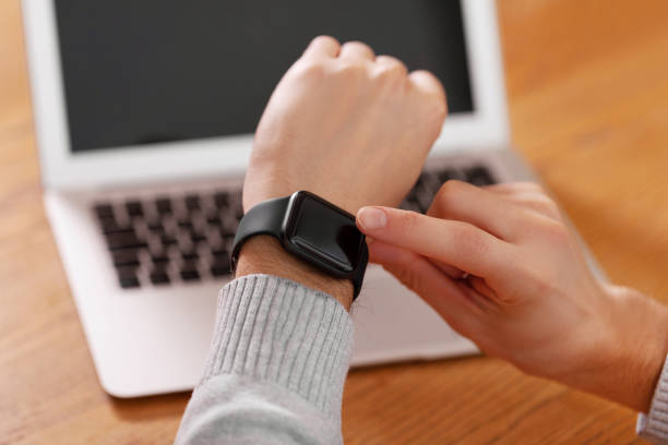 istock Men's hand touching watch on top view. Can be used as mock up 1134322880