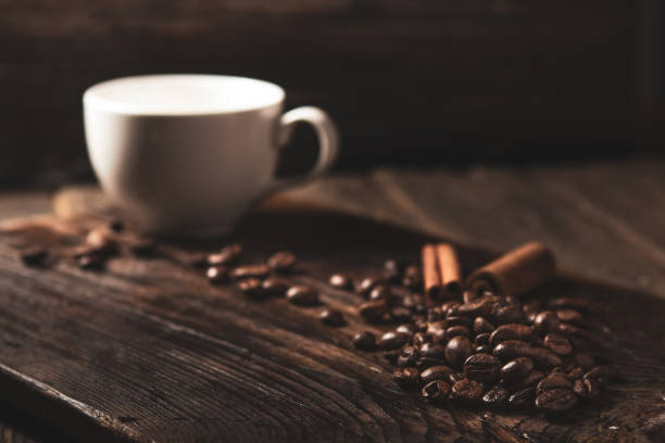 istock Coffee beans and white mug on wood 1134325296