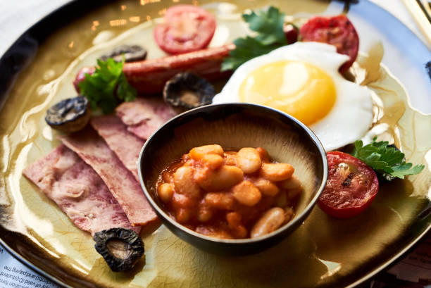 istock English breakfast with sausages, scrambled eggs, bacon, mushrooms and beans 1134325435