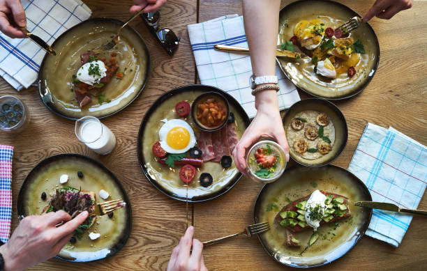 istock Group of people having breakfast and sitting at table, top view 1134325712