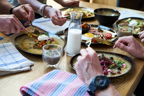 istock Friends group having english breakfast at cafe restaurant, close-up. 1134325901
