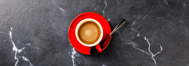 istock Coffee in a red cup on the Dark Marble Background.Cappuccino or latte .Copy space for Text. Top View. Flat Lay. Banner 1134326819