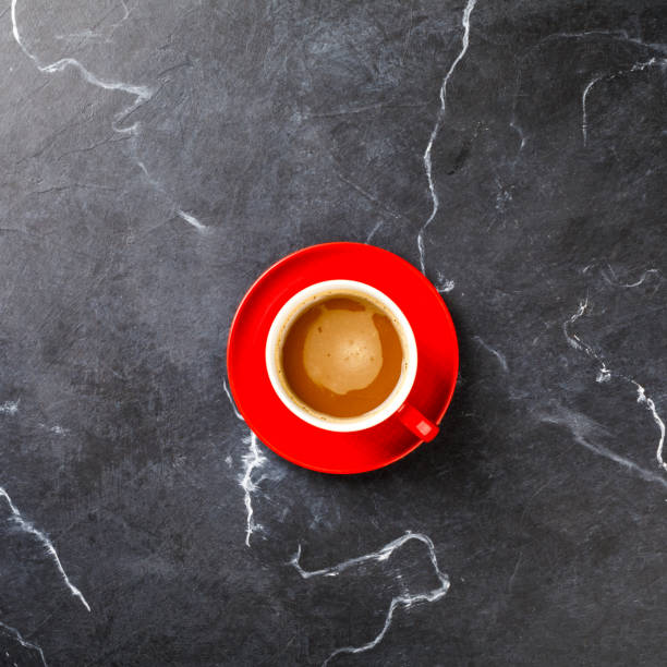 istock Coffee in a red cup on the Dark Marble Background.Cappuccino or latte .Copy space for Text. Top View. Flat Lay. 1134326820