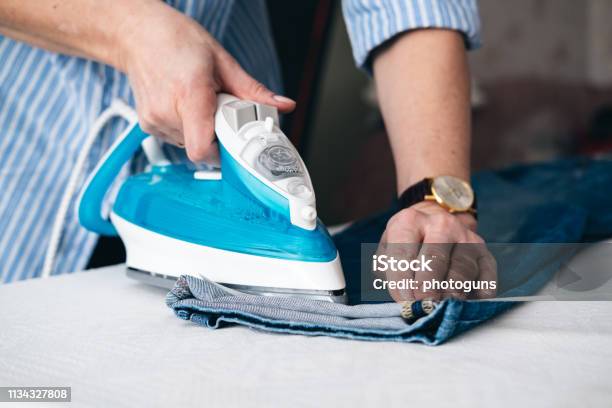 Seamstress Ironing Jeans In Tailor Shop Stock Photo - Download Image Now - Iron - Appliance, Jeans, 30-39 Years