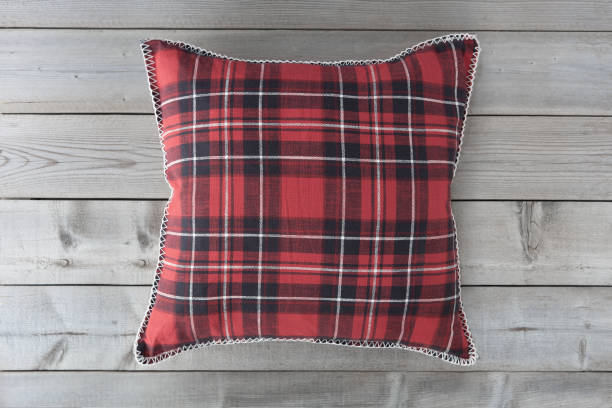 istock Red plaid square cushion on grey wooden background. 1134334253