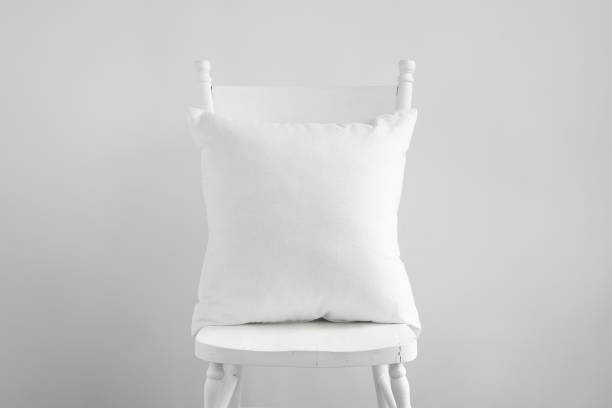 White square cushion mockup on white wooden chair.